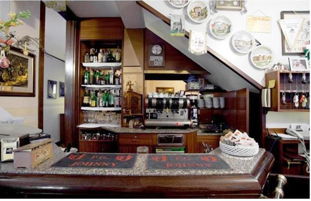 a kitchen with a counter and a shelf with dishes at Locanda Da Renzo in Treviso