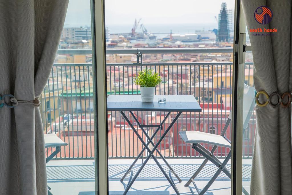 a dining room table with a window overlooking a city at South Hands in Naples
