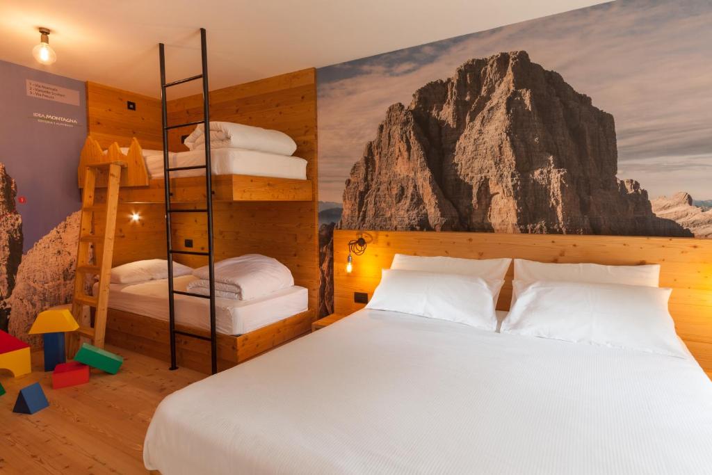 A bed or beds in a room at Rifugio La Montanara