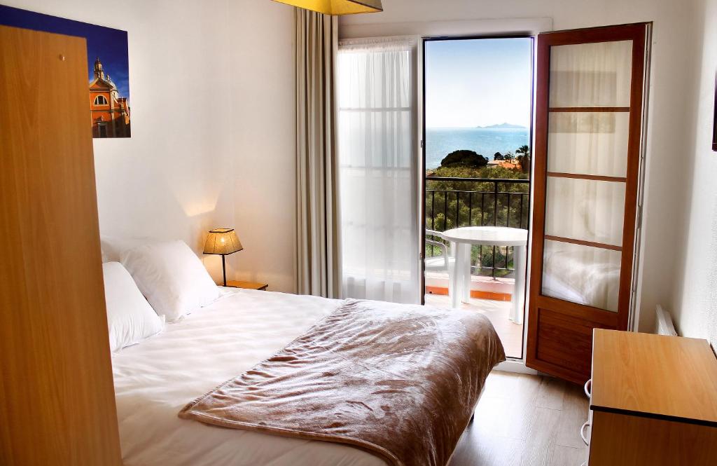 a bedroom with a bed and a large window at Creste E Mare in Ajaccio
