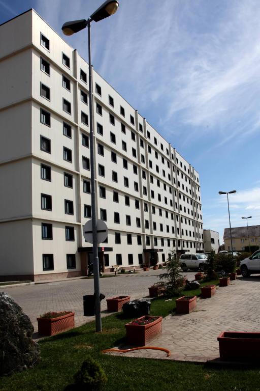 a large white building with a lot of windows at Aksai Residence in Aksay