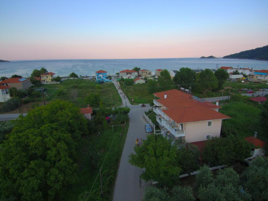 an aerial view of a small town with a road and houses at Porto Thassos Apartments & Studios in Skala Potamias