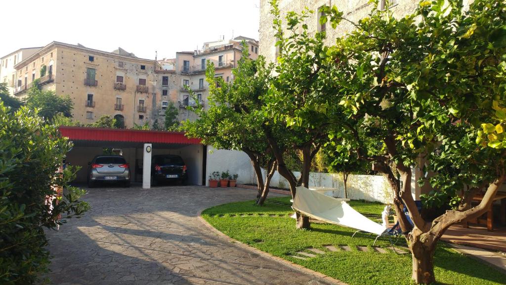 a hammock in a park in front of a building at The Lemon Tree House in Scalea