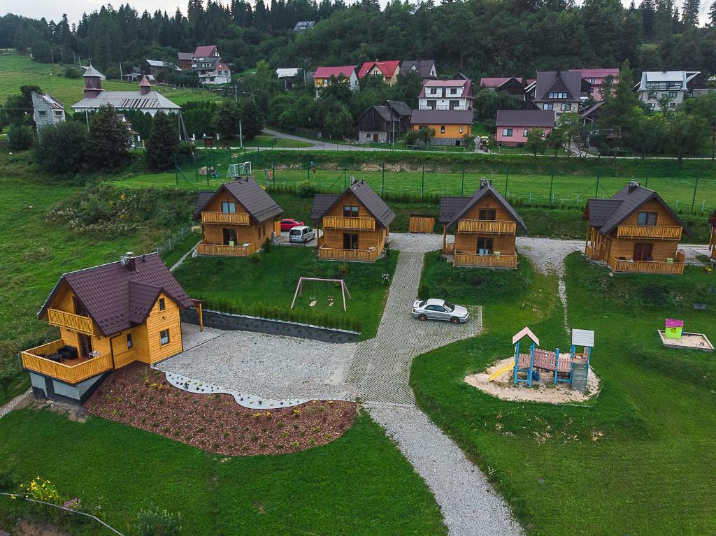 an aerial view of a village with houses and a playground at Domki Falsztyn in Falsztyn