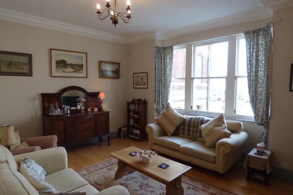 a living room with a couch and a table at Abbey View in Kelso