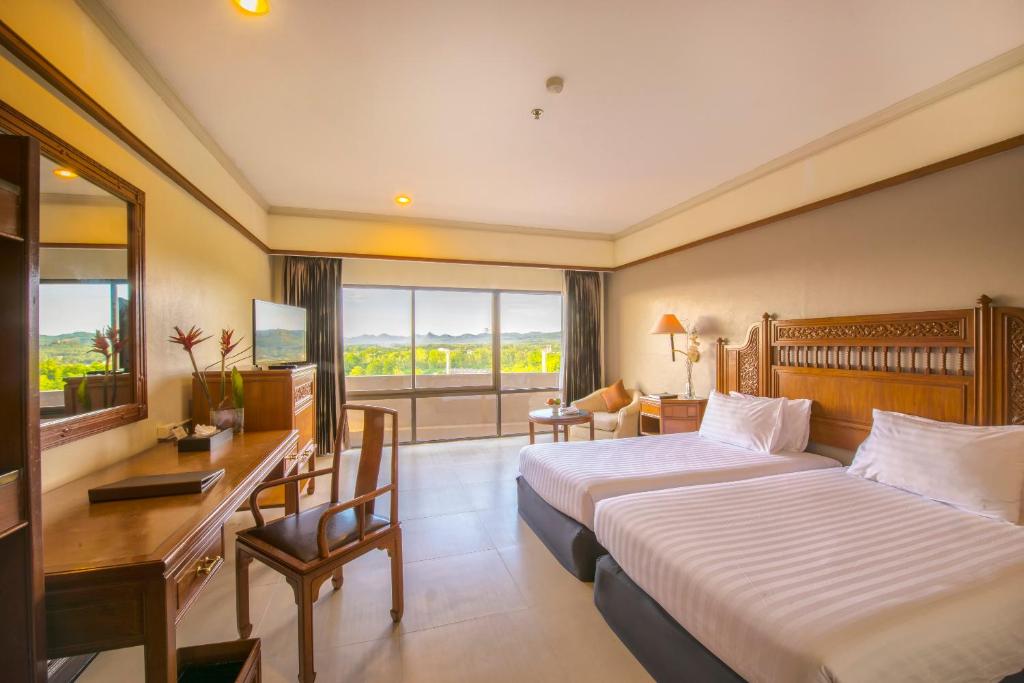 Postel nebo postele na pokoji v ubytování Loei Palace Hotel