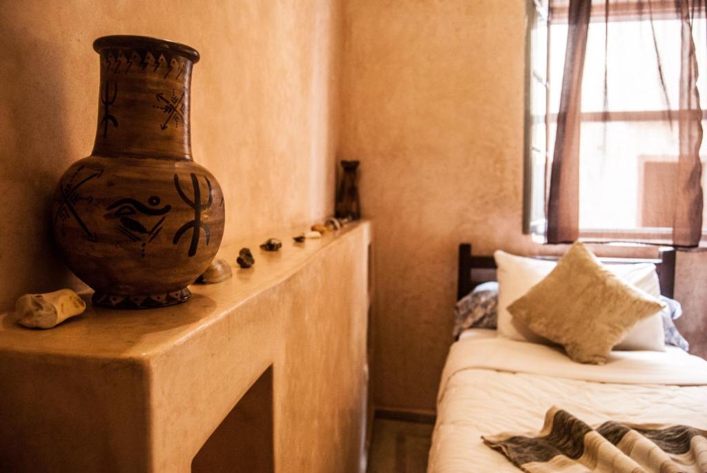 Postel nebo postele na pokoji v ubytování Riad Dar Latigeo