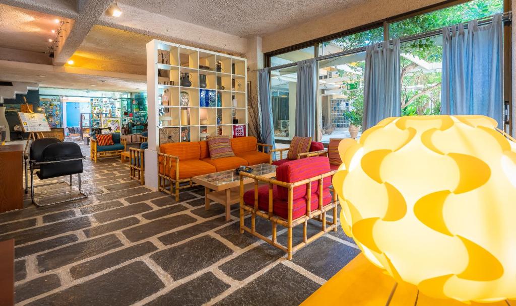 a room with chairs and a couch and a table at Apollonia Hotel Apartments in Varkiza