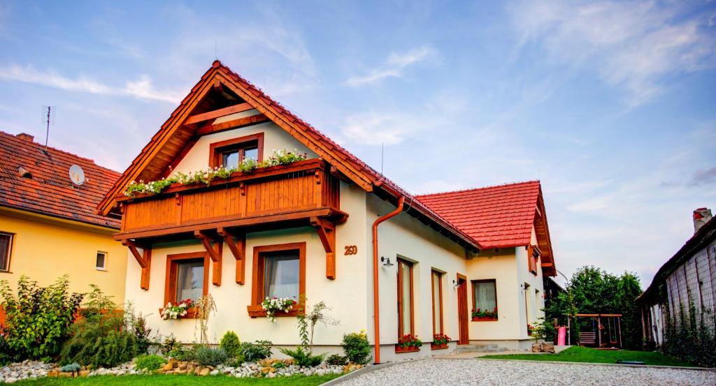 a house with a red roof at Apartmány Bobrík in Liptovský Mikuláš