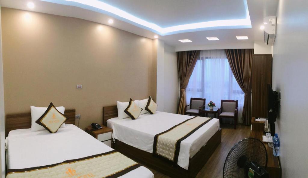 a hotel room with two beds and a window at Sky hotel 390 QUang Trung Thành phố Uông Bí tỉnh Quảng Ninh in Uông Bí