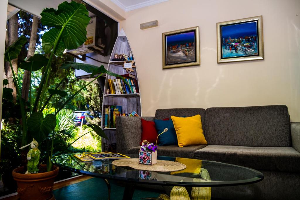 a living room with a couch and a glass table at Sezoni South Burgas in Burgas