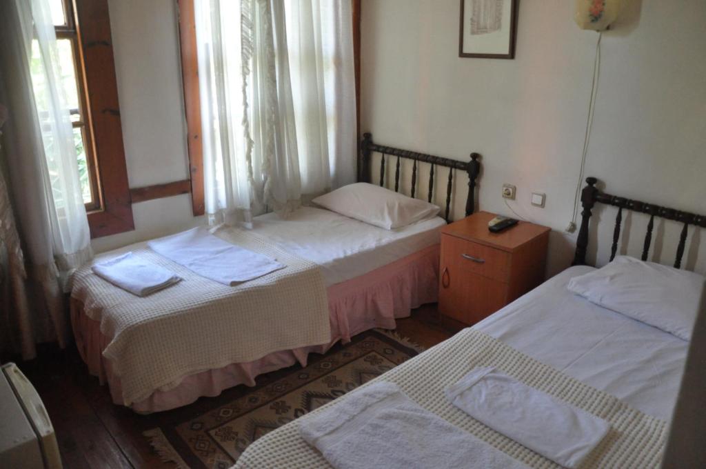 a room with two beds and a window at Kont Pension in Antalya