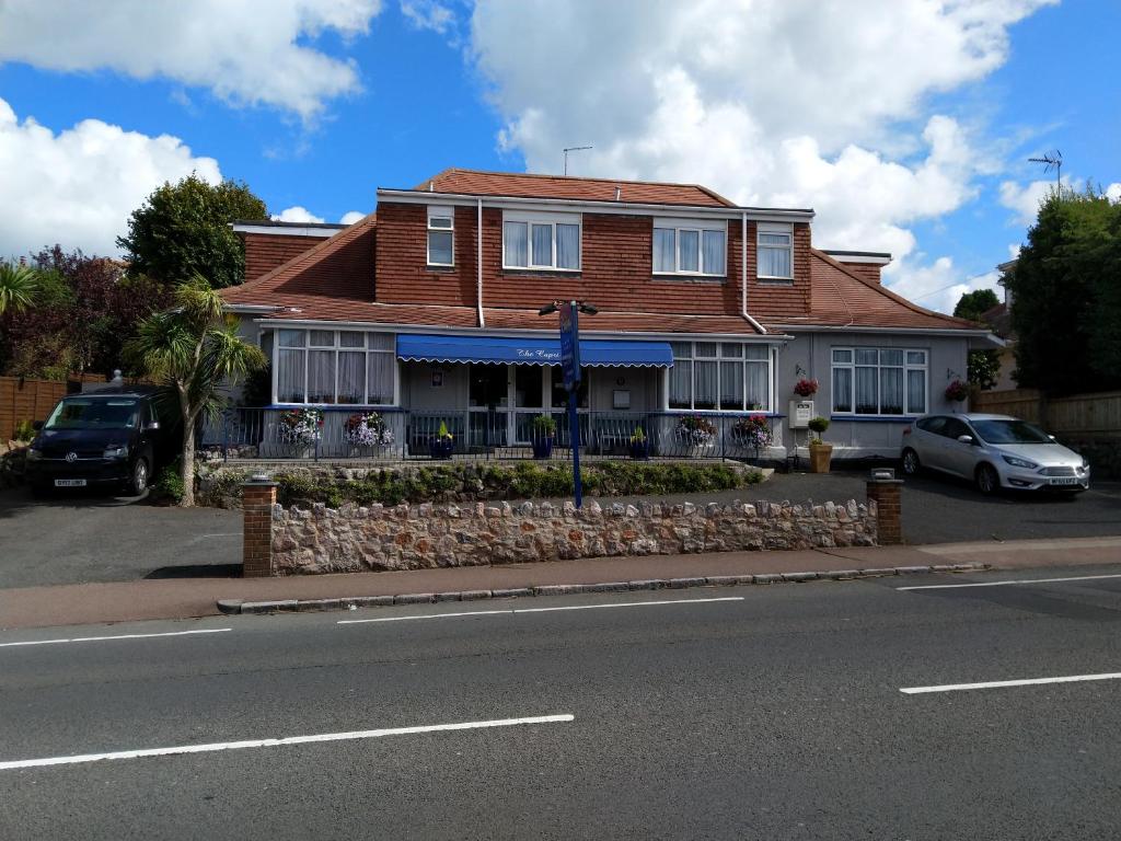 a house with a car parked in front of it at Capri Guest House in Torquay