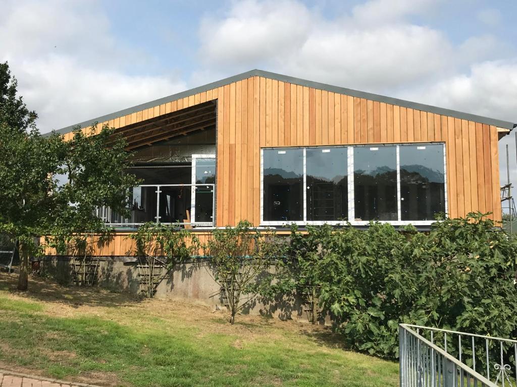 a building with windows on the side of it at Godshill Park Barn in Ventnor