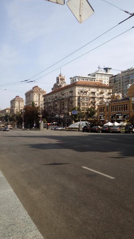 an empty street in a city with tall buildings at Smile Khreschatyk Kyiv in Kyiv