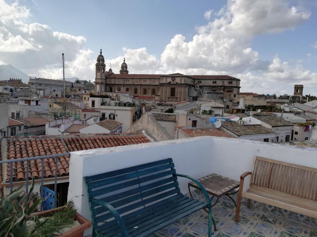un banc bleu assis sur un balcon donnant sur une ville dans l'établissement Casa in palazzo Graffeo Sven, à Palerme