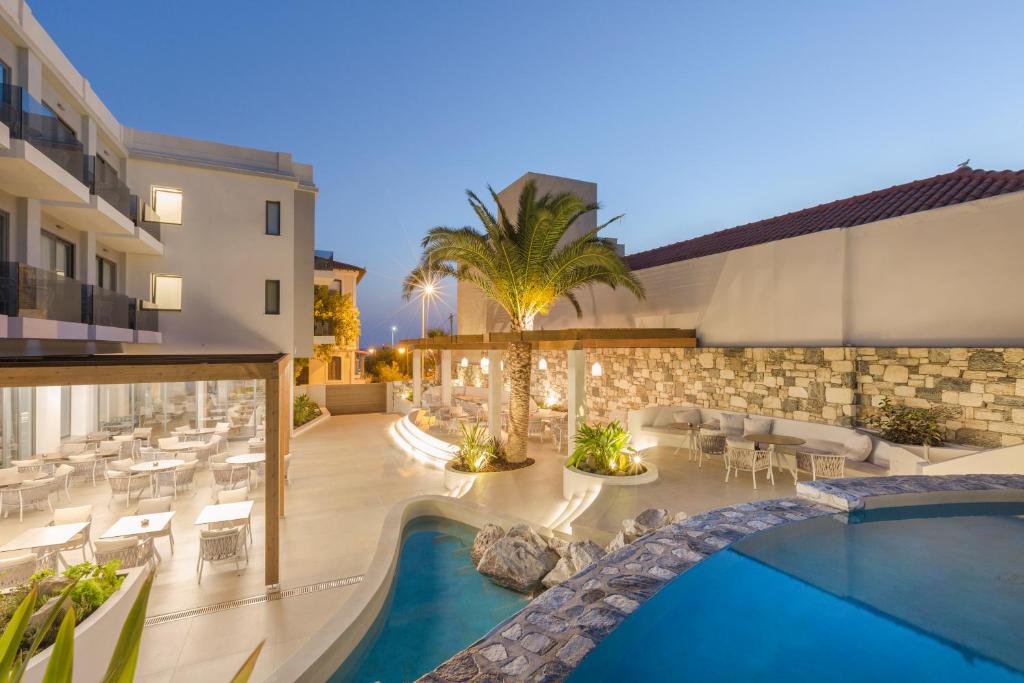 a view of the pool and patio of a hotel at Samian Mare Hotel, Suites & Spa in Karlovasi