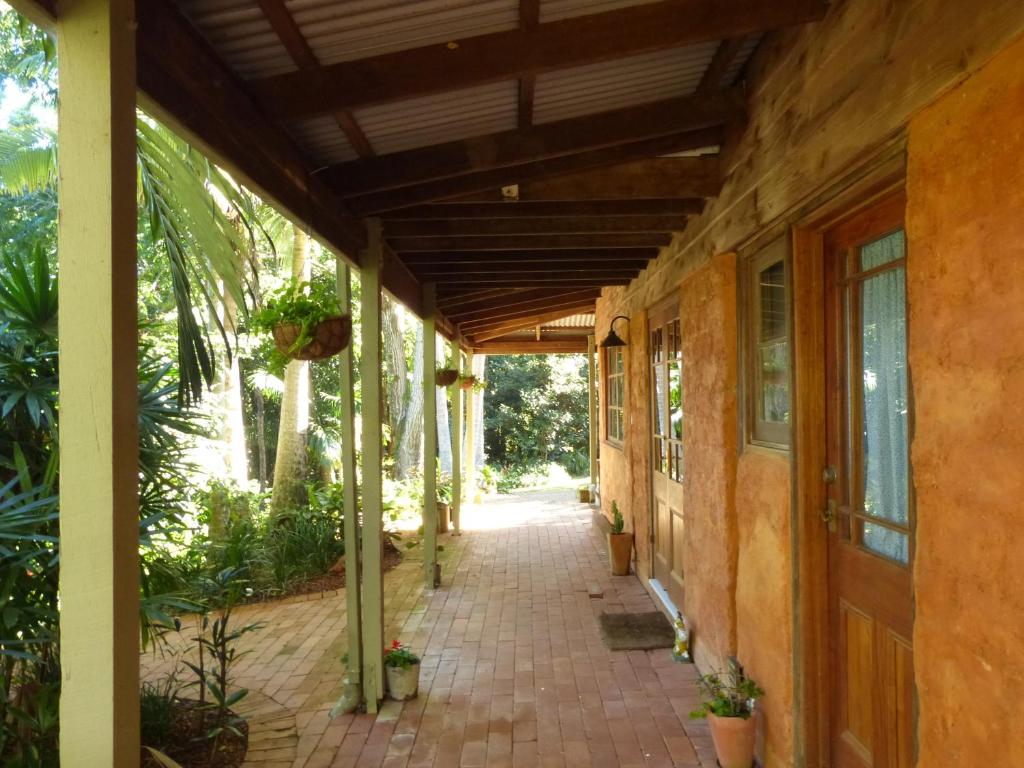 a walkway outside of a house with a porch at The Stables in Cooroy