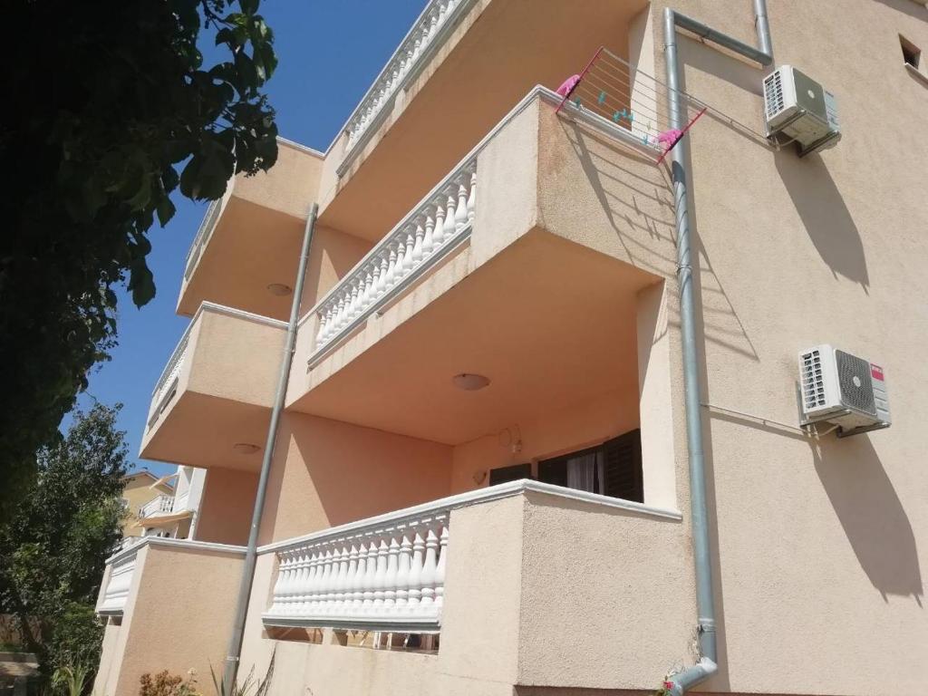 a apartment building with a balcony and a staircase at Apartment Plavia Biograd in Biograd na Moru