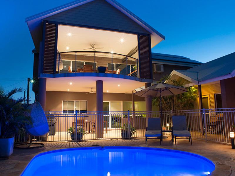 a house with a swimming pool in front of it at Gecko Lodge Kalbarri in Kalbarri