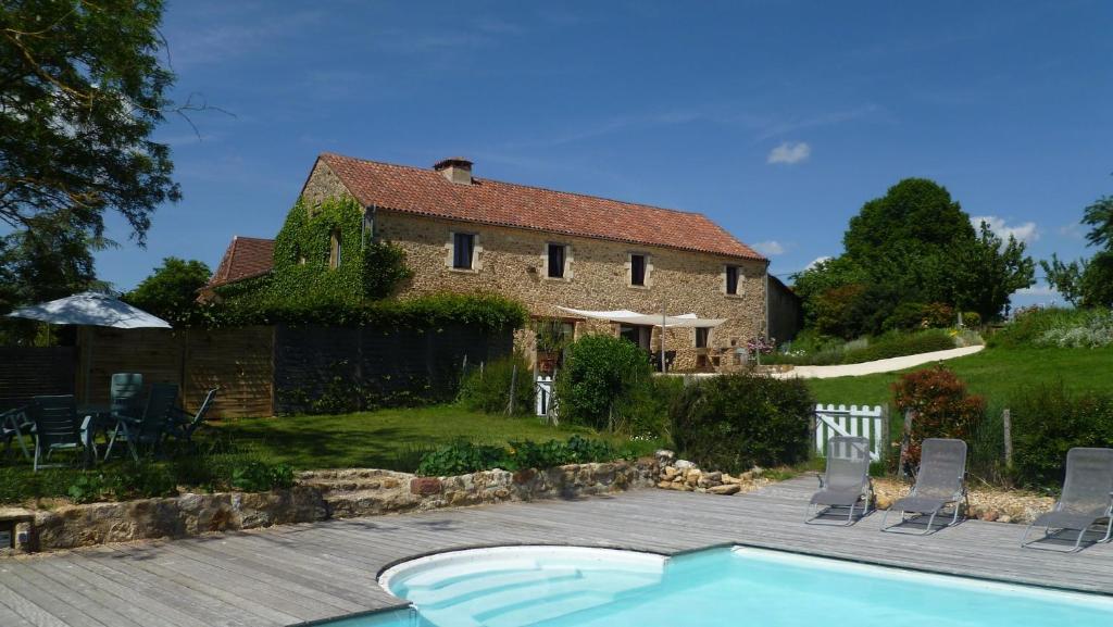 a house with a swimming pool in front of a house at La Garipiere in Carvès