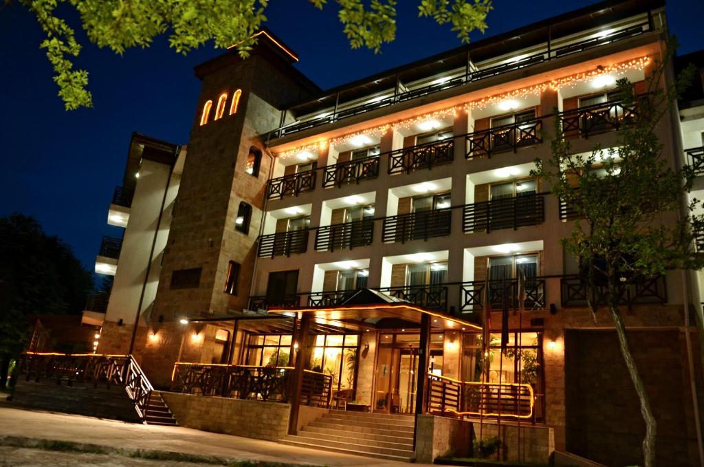 a large building with lights on it at night at Spa Hotel Kleptuza in Velingrad