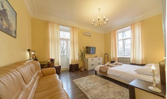 a living room with a bed and a couch at Smile Khreschatyk Kyiv in Kyiv
