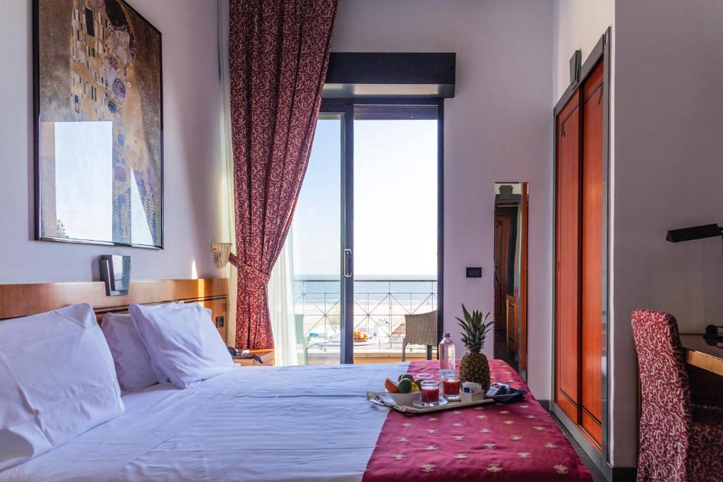 Säng eller sängar i ett rum på Hotel Nettunia