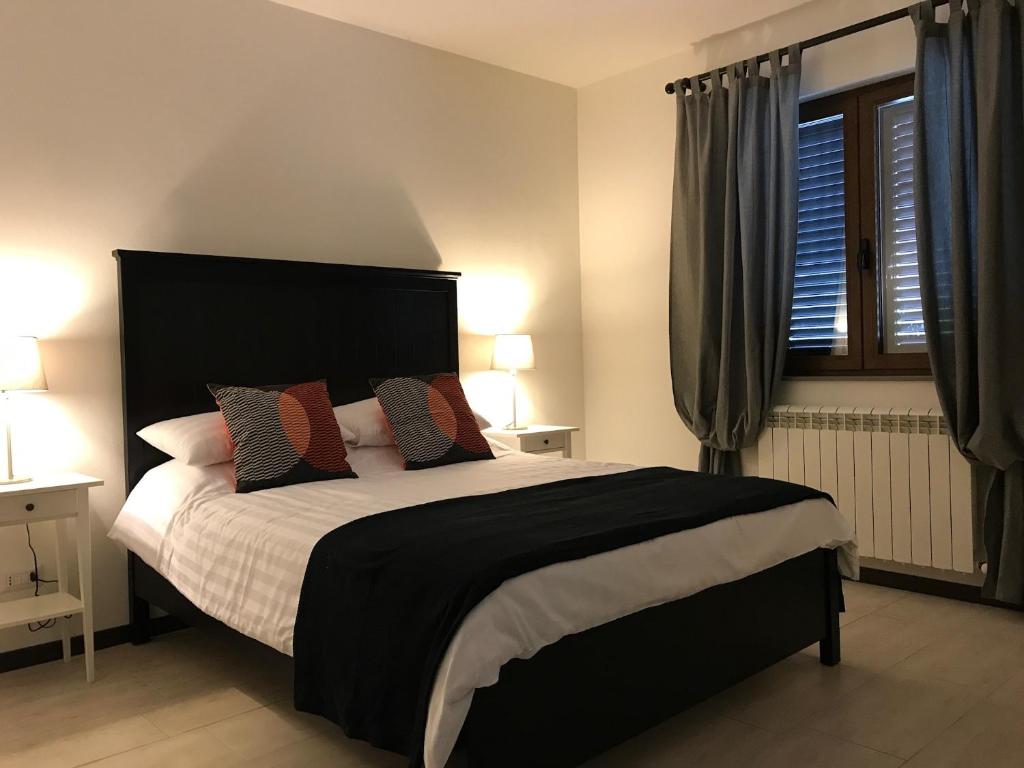a bedroom with a large bed and a window at Casa Elena in Camporgiano