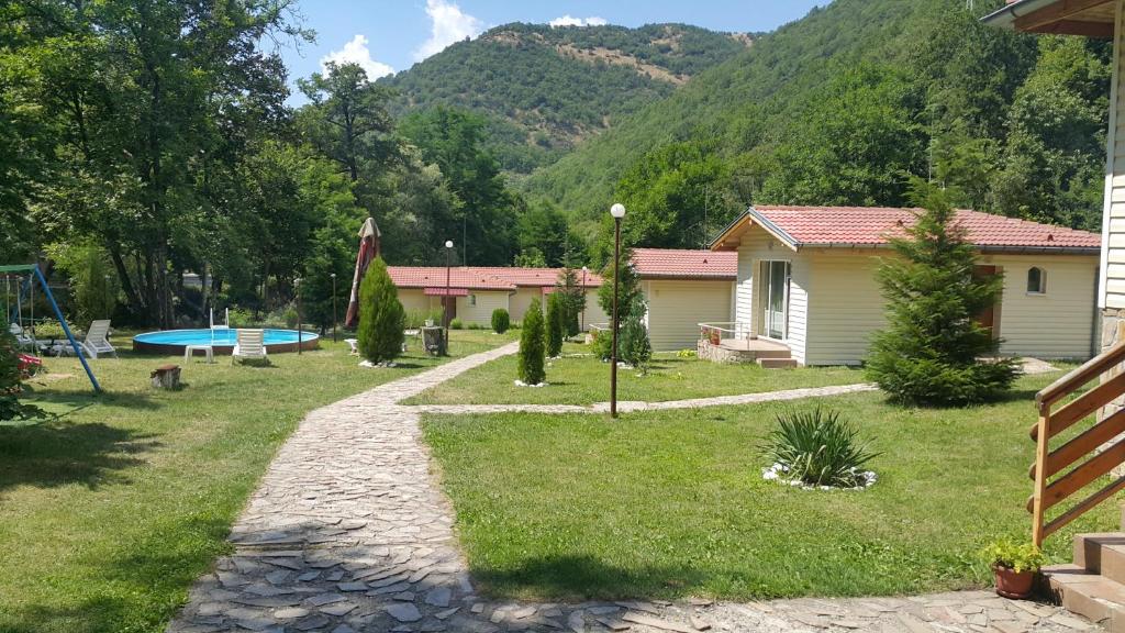 a yard with a house and a playground at Hotel Valdis in Pastra