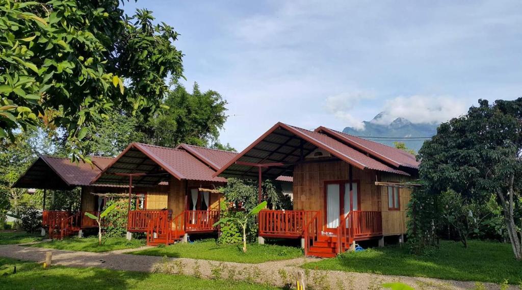 a house with orange chairs in front of it at Chiang Dao Reset in Chiang Dao