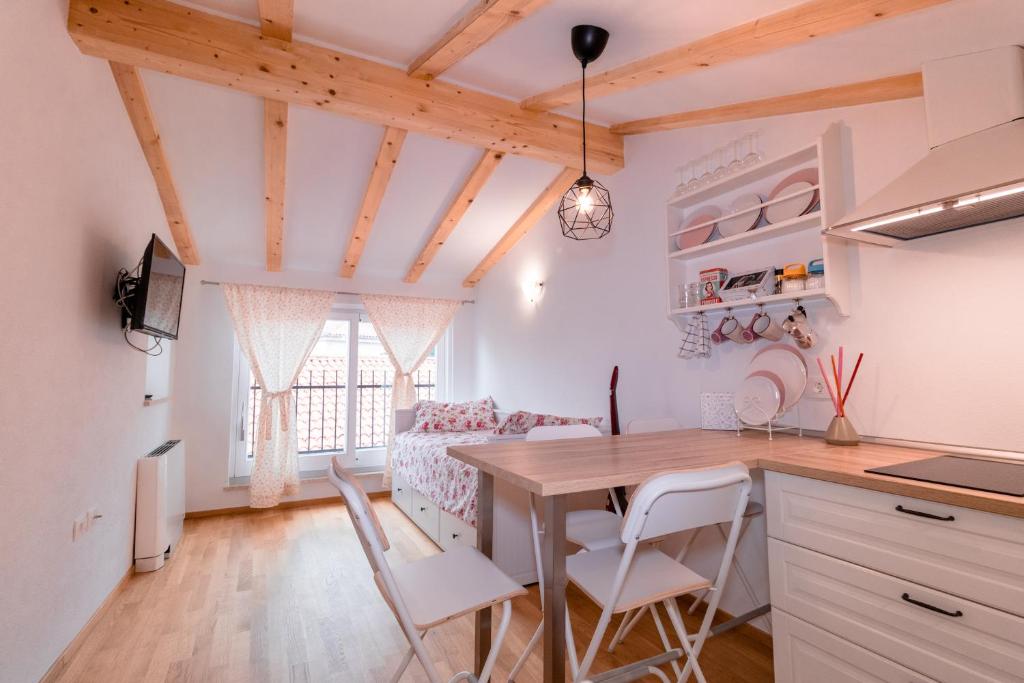 a kitchen and dining room with a table and chairs at Apartments Pia in Piran