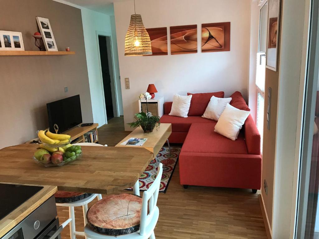 a living room with a red couch and a table at Louisenstraße 31 in Dresden