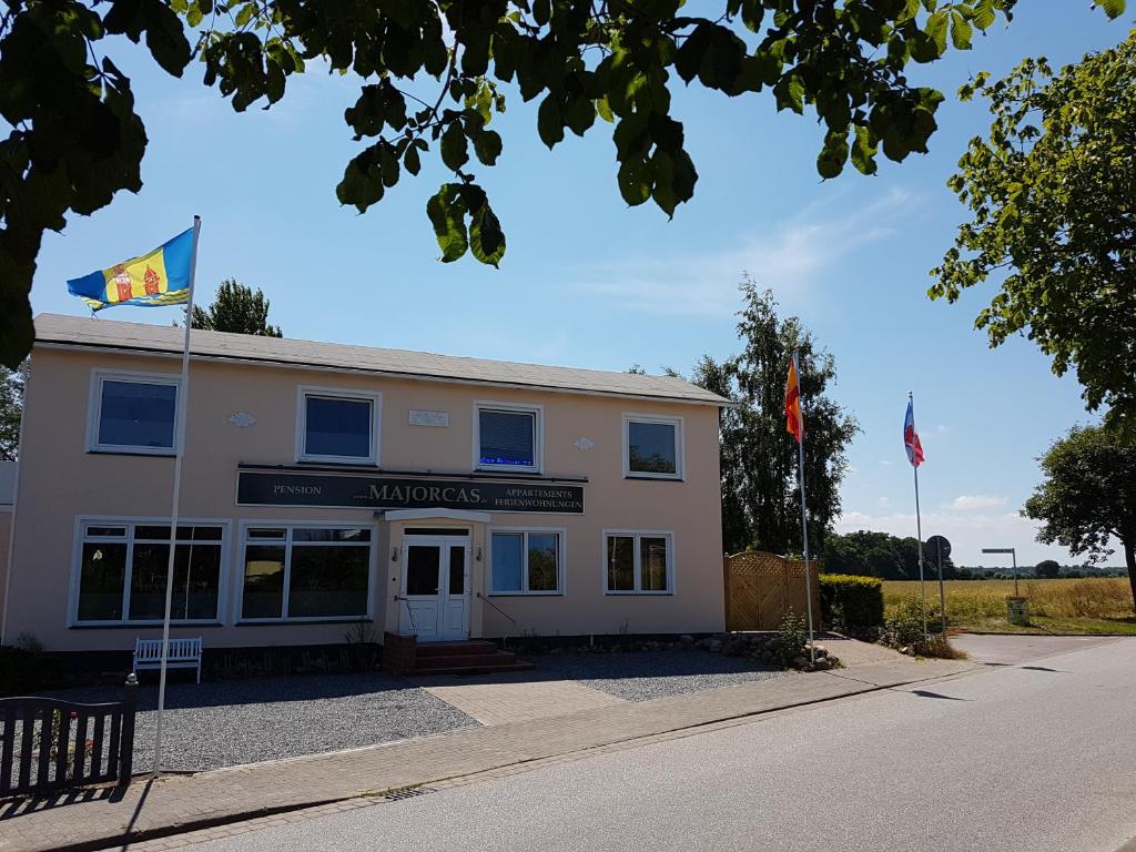 a building with two flags in front of it at Ferienwohnanlage Majorcas in Dahme