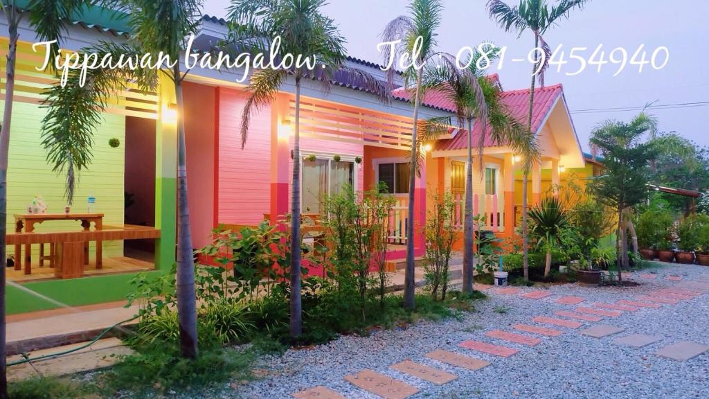a colorful house with a table in front of it at Thippawan Bungalow in Ko Si Chang