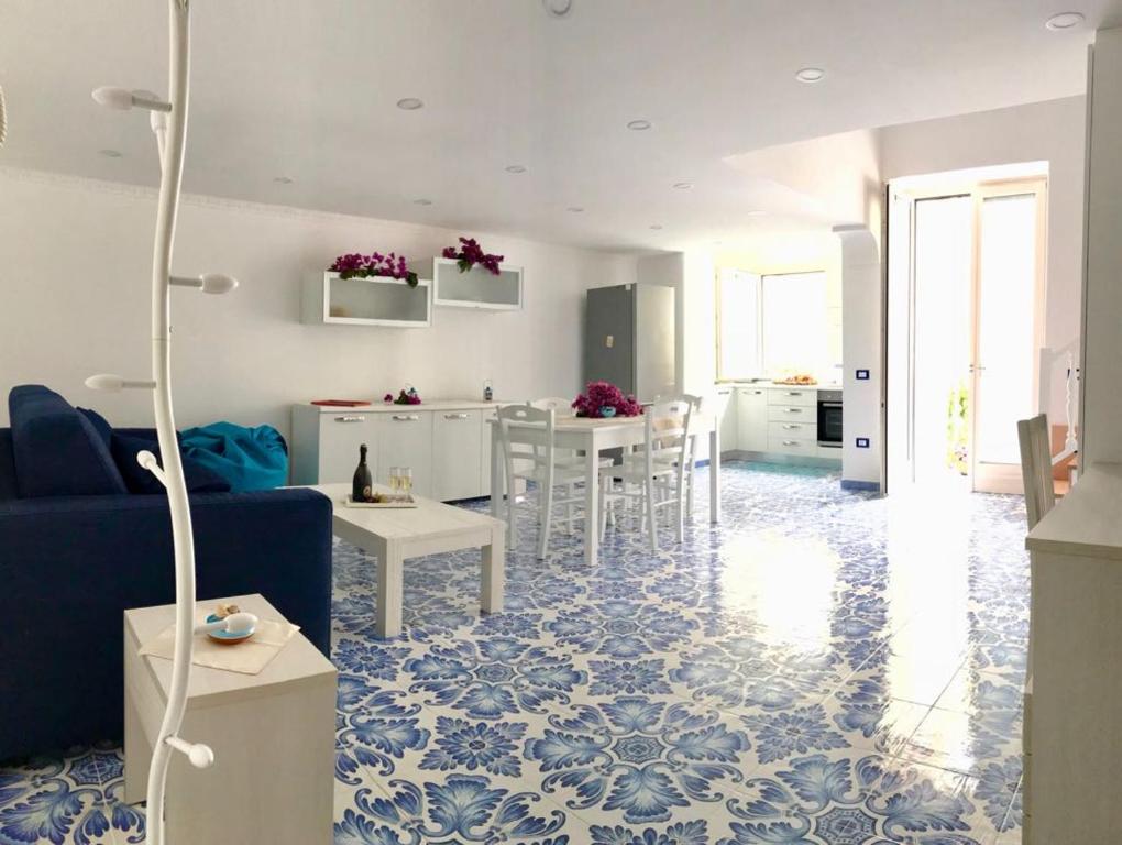 a living room with a blue and white floor at Casetta del pescatore in Ischia