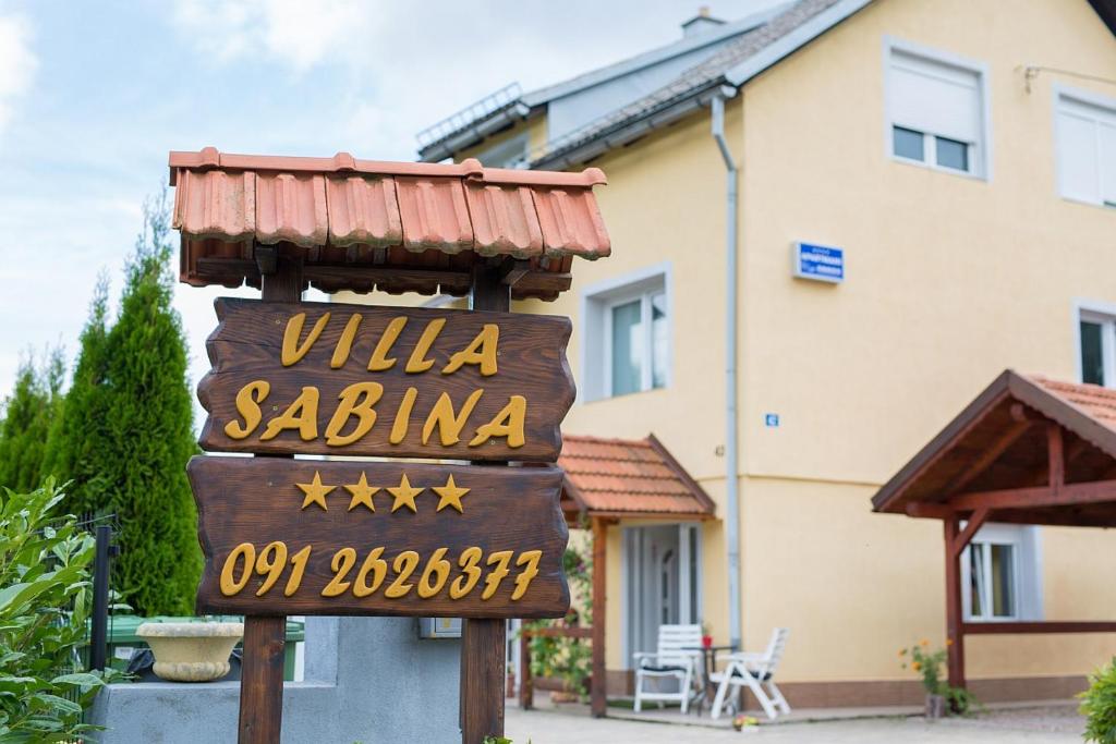 a sign for a villa sauna in front of a building at Villa Sabina in Fužine