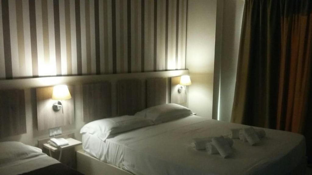 Postel nebo postele na pokoji v ubytování Hotel Cliché
