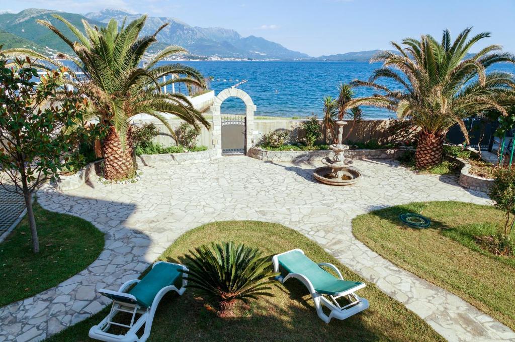 a patio with two lounge chairs and the ocean at Apart Hotel Apple Cat Montenegro KO Bijela in Bijela