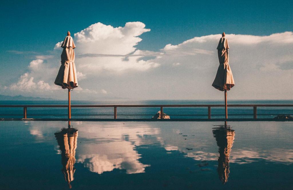 two umbrellas sitting on top of a swimming pool at Langkhai Garden in Koh Tao