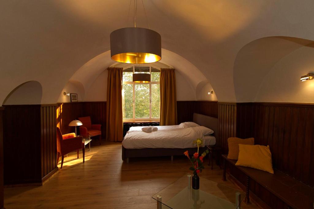 Schlafzimmer mit einem Bett, einem Fenster und einem Tisch in der Unterkunft B&B Villa Anna, Venlo in Venlo