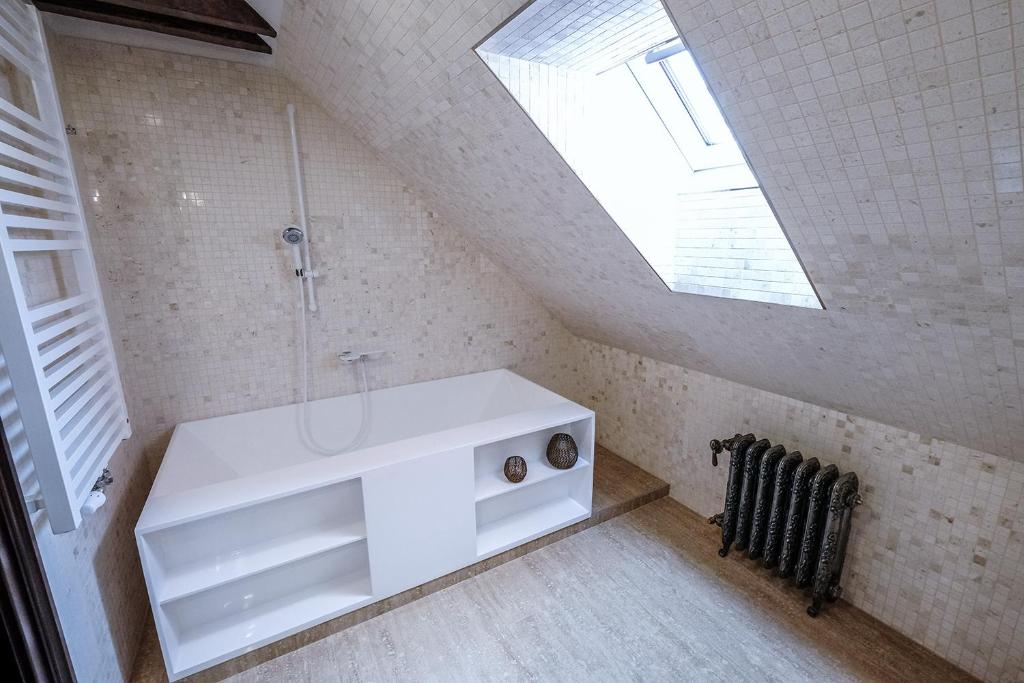bagno con lavandino bianco e lucernario di Hotel Ebersbach a Cesky Krumlov