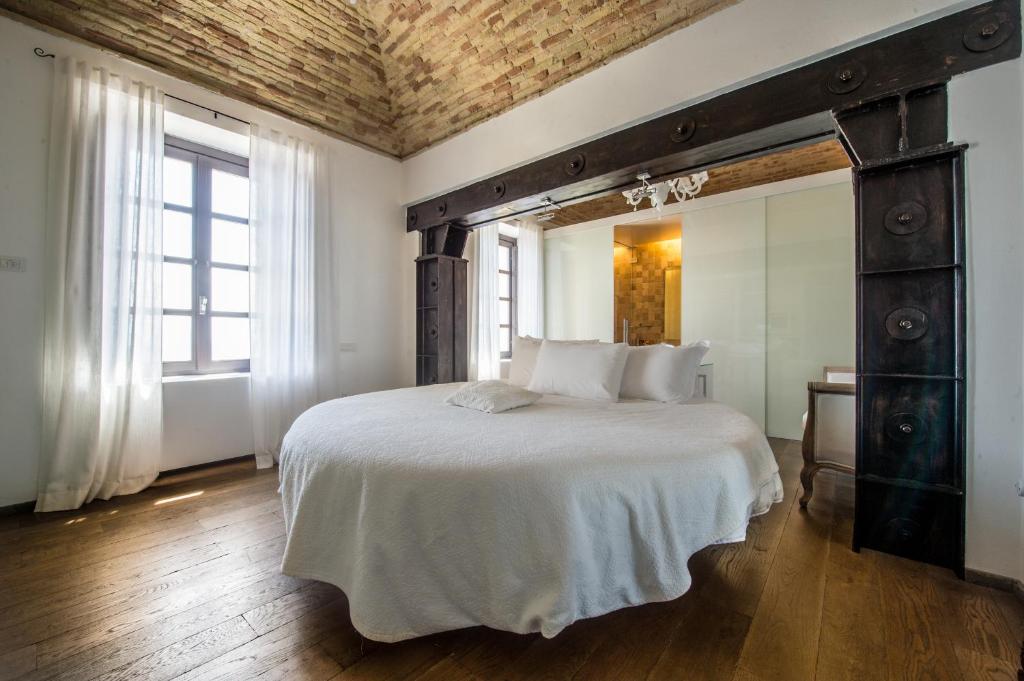 a bedroom with a large bed and a large mirror at Faro Capo Spartivento in Chia