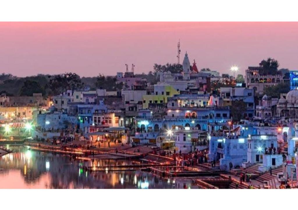 a view of a city at night with lights at Budget rooms on VIP road in Pushkar