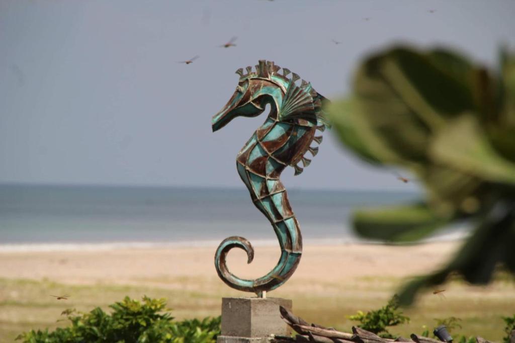 a statue of a seahorse sitting on a rock at C Beyond Nilaveli in Nilaveli