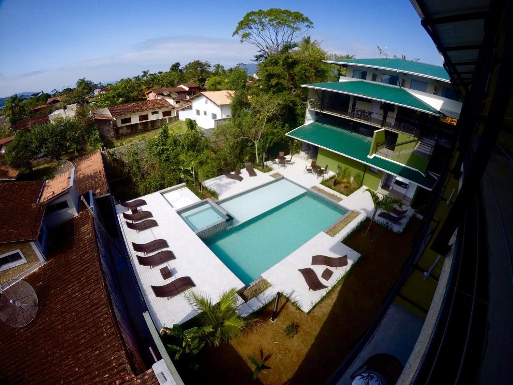 an aerial view of a house with a swimming pool at Luz da Lua Pousada in Ubatuba