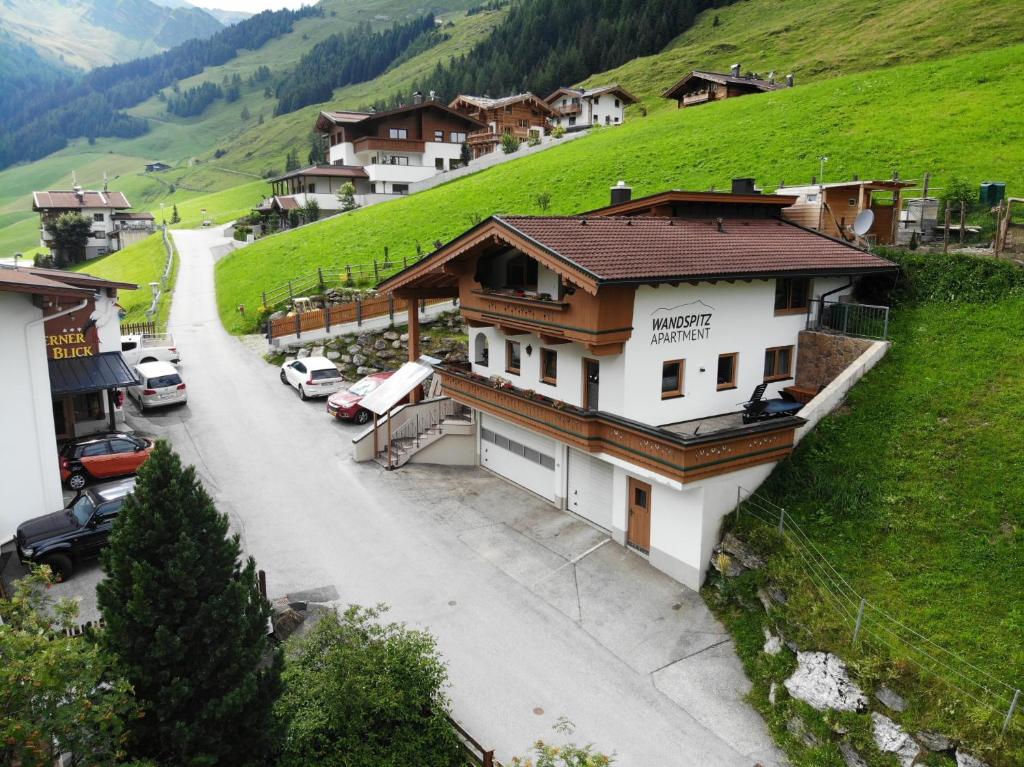 a village with cars parked on the side of a hill at Apartment Wandspitz in Hintertux