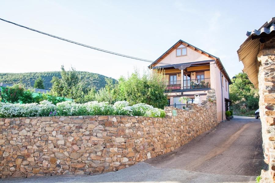 a stone wall in front of a house at El Mirador del Bierzo in Tejedo