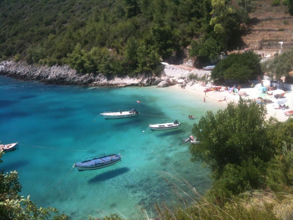 a group of boats in the water on a beach at Manto's House Lefkada in Évyiros