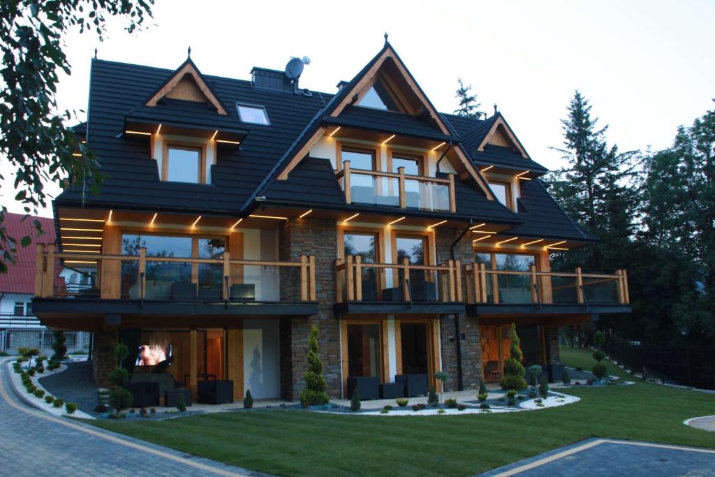 a house with a gambrel roof at Rezydencja Sobiczkowa Apartamenty in Zakopane